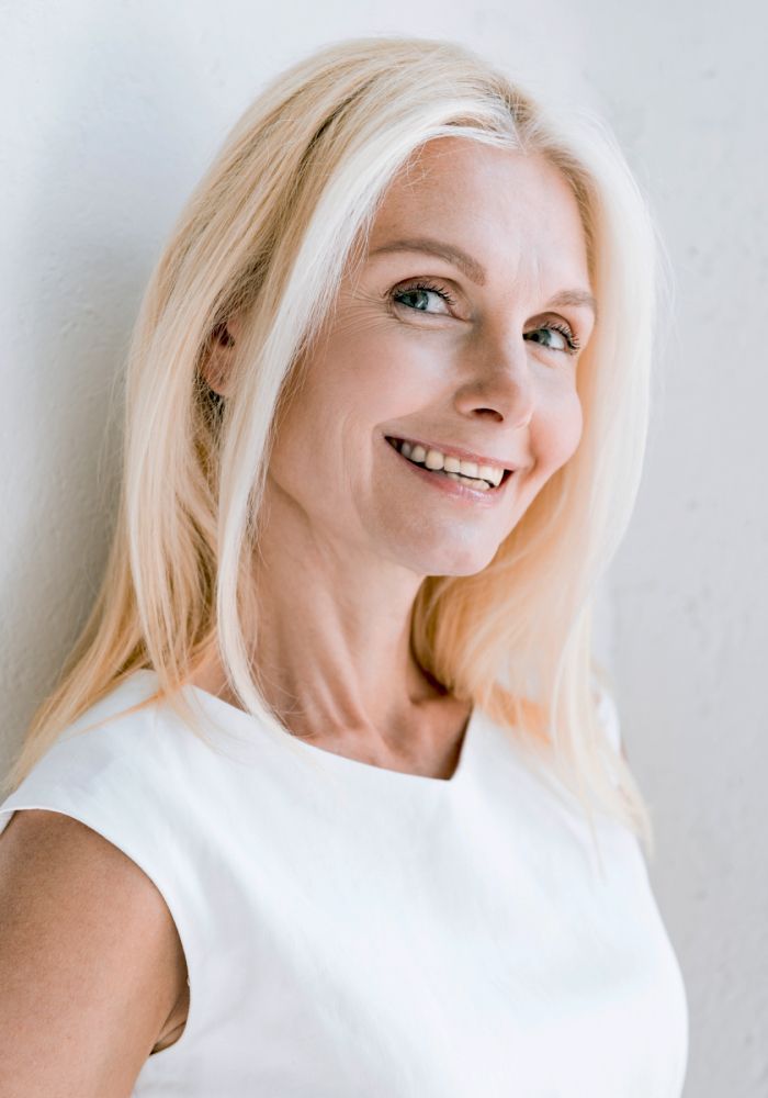 Smiling woman with long blonde hair.